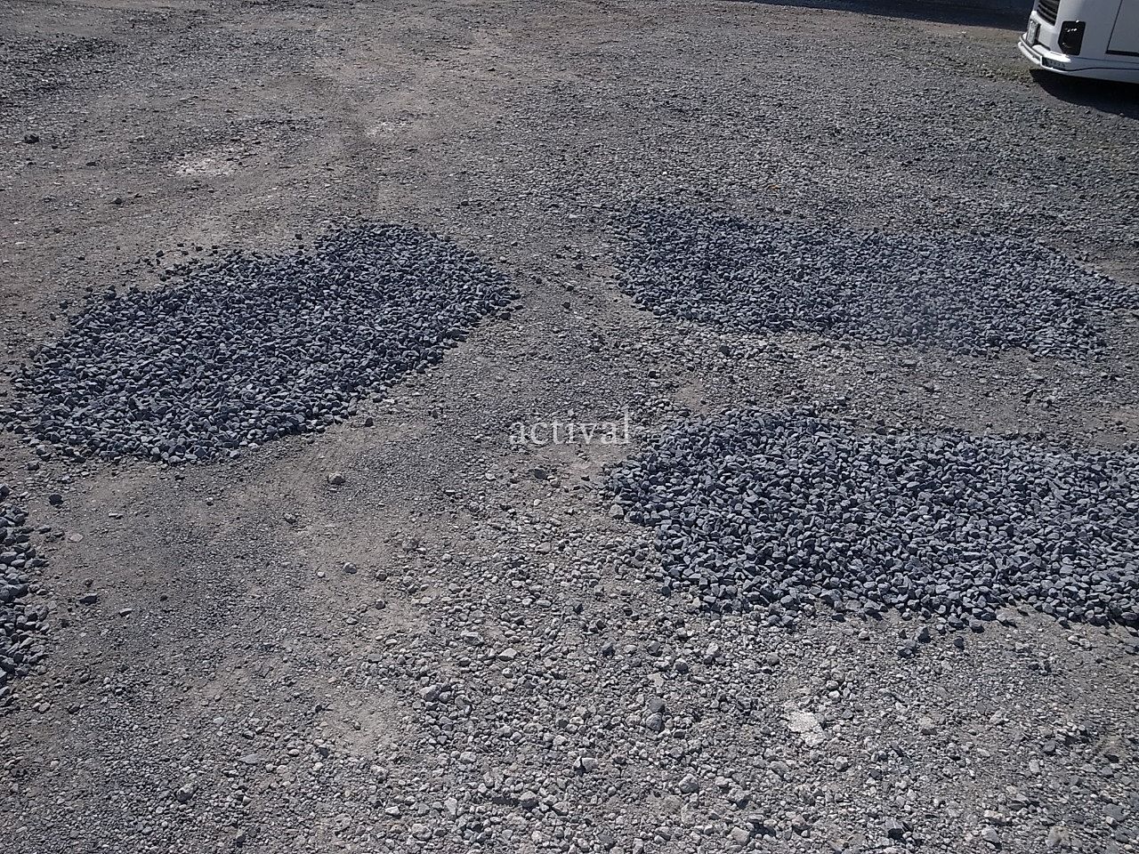 月極駐車場の窪みに砕石を入れます。